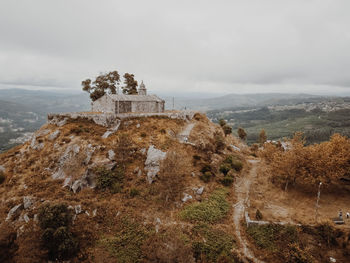 Built structure on hill against sky