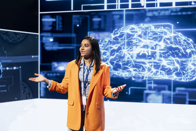 Portrait of young woman standing in city