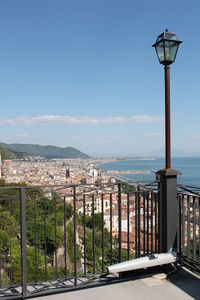 Street by sea against sky in city