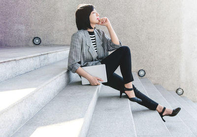 Woman sitting on staircase