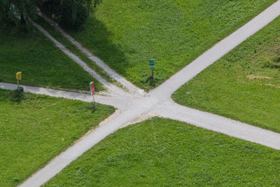High angle view of road amidst green field