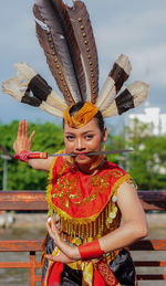 Portrait of smiling woman with costume standing outdoors