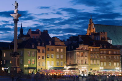 Warsaw old town by street against sky at night