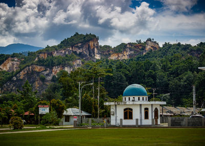 Buildings against cloudy sky