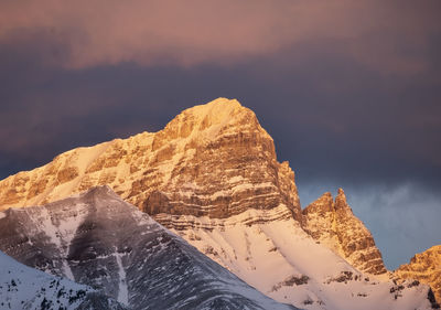 Scenic view of snowcapped mountains against sky at sunrise