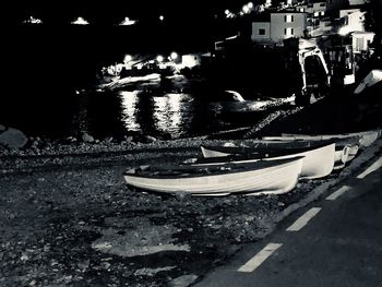 Boats moored in canal in city