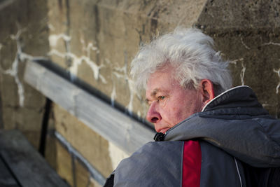 Thoughtful senior man sitting on bench