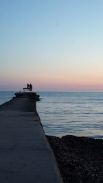 Scenic view of sea against clear sky at sunset