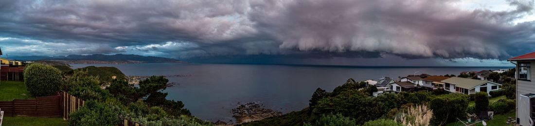 Panoramic view of sea and buildings against sky