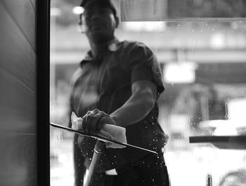 Worker cleaning glass