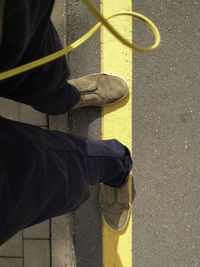 Low section of man standing on street