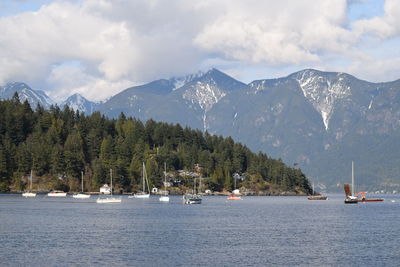 Scenic view of sea and mountains against sky