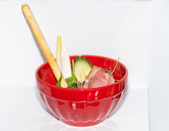 Close-up of fruits in bowl against white background