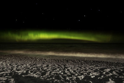 Scenic view of land against sky at night