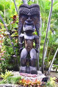 Statue of buddha against plants