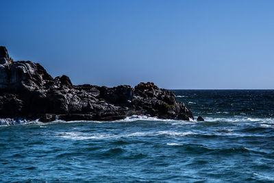 Scenic view of sea against clear blue sky