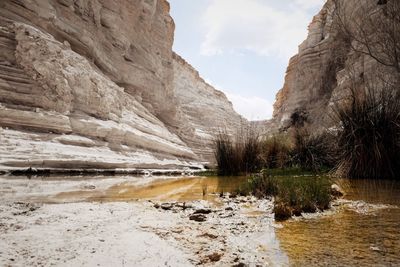 Scenic view of river amidst mountains against sky