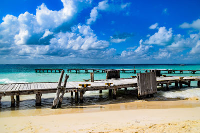 Scenic view of beach against blue sky