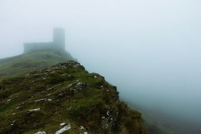 Scenic view of tree mountains against sky during foggy weather