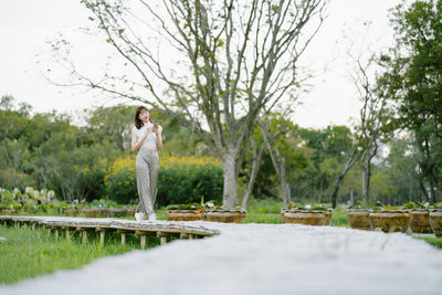 Full length of man standing against trees