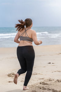 Rear view of woman on beach