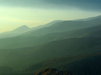 Scenic view of silhouette mountains against sky