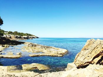 Scenic view of sea against clear blue sky