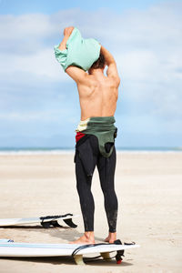 Rear view of woman exercising in sea