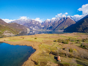 Scenic view of snowcapped mountains against blue sky