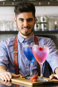 Bartender with drinks in restaurant