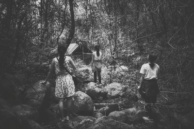 Man standing on rock in forest