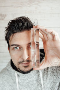 Mid adult man holding prism