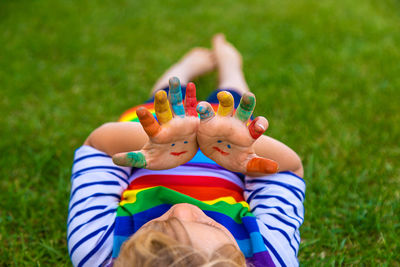 High angle view of boy sitting on grass
