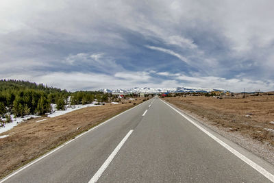 Surface level of empty road against sky