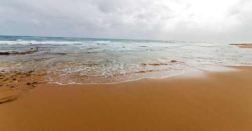 Scenic view of beach against sky