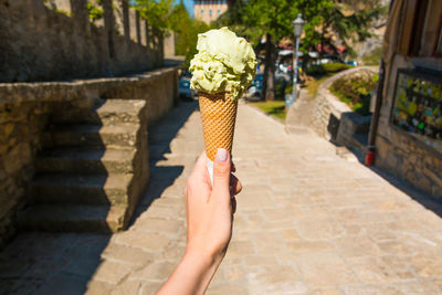 Close-up of hand holding ice cream cone