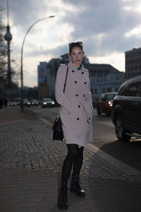 Portrait of young woman walking on street