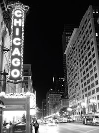 Low angle view of buildings lit up at night