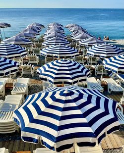 High angle view of chairs on beach against sea