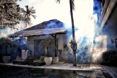 Panoramic shot of building and trees against sky