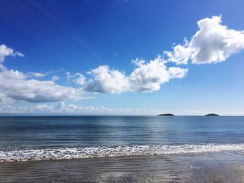 Scenic view of calm sea against cloudy sky