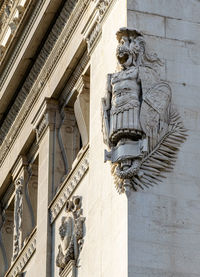 A view of roman armour etched in stone decorating one of the buildings around the city of rome