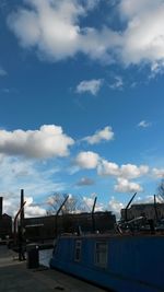 Buildings against cloudy sky