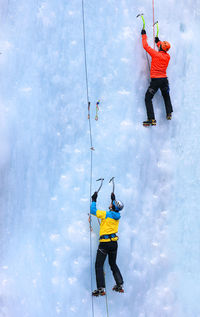 Rear view of people ice climbing