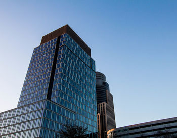 Low angle view of modern building against clear blue sky