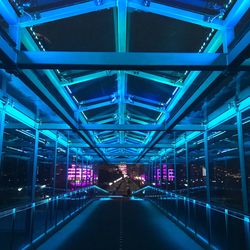 Illuminated covered bridge in city at night