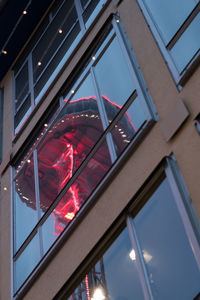 Low angle view of illuminated building against sky