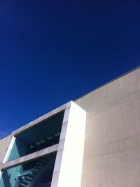 Low angle view of building against clear blue sky