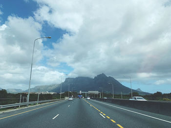 Cars on highway against sky