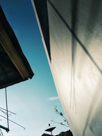 Low angle view of airplane flying against sky